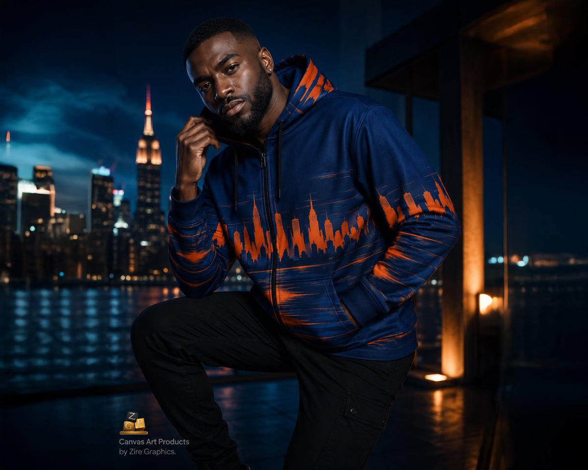 A man wearing a navy blue hoodie with a bright orange abstract graphic pattern across the chest and sleeves, posed against a dark city skyline at night.